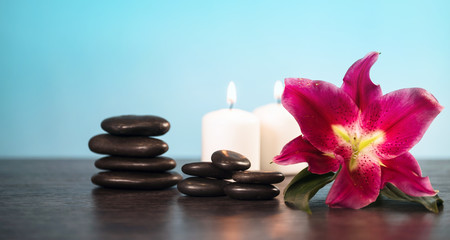 Nature products Spa and wellness setting with flowers, towels, stones and candle