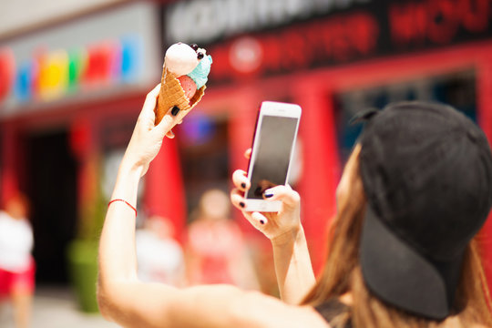 Summer girl taking picture of ice cream