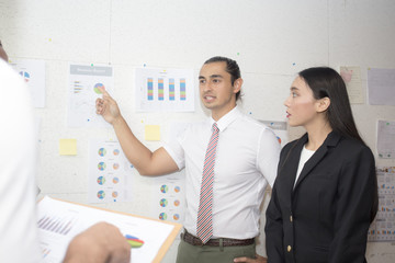 Young businessman present business plan with team at meeting room, man with leader concept, 20-30 years old.