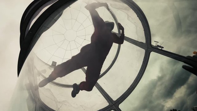 Woman flying in a wind tunnel. Indoor skydiving wind tunnel. Extreme parachuting