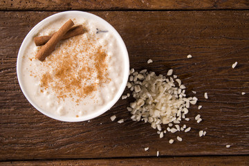 Brazilian dessert sweet canjica of white corn with pacoca sweet in bowl and towel. Festa Junina Party Brazilian Culture Concept Image.