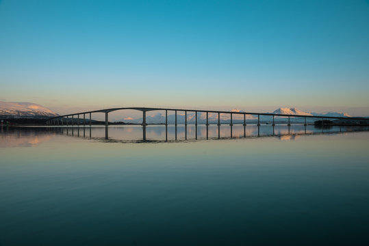 Sunset over bridge. Sandnessund bridge is cantilever road bridge that crosses the Sandnessundet strait between the islands of Troms&oslash;ya and Kval&oslash;ya. Tromso ( Troms&oslash; ), Norway