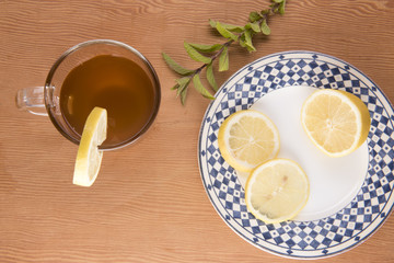 Chai tea with lemon slices and green foliage 