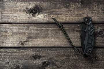 Clasp-knife on wooden backdrop