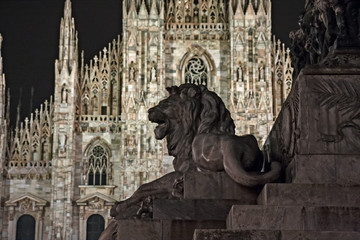 Equestrian monument to "Vittorio Emanuele II". In the background the "Duomo" of Milan with its Gothic spheres at night.