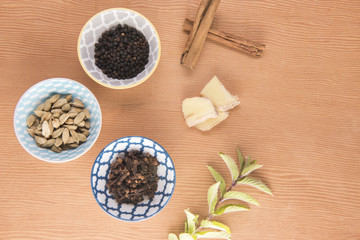 Ingredients of Chai tea on a wooden background 
