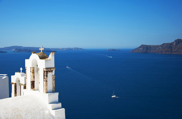 Traditional Greek architecture and a view of the blue sea over a white terrace. Santorini, Cyclades, Greece.