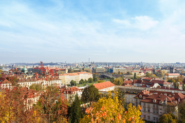 Fototapeta na wymiar Amazing aerial view from top on Prague, Czech Republic. Yellow trees, red roofs and blue sky.