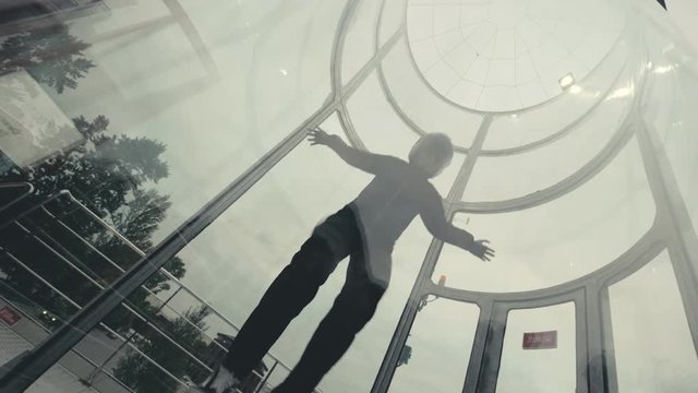 Man skydiver flies in wind tunnel. Flying in a wind tunnel. Extreme sports