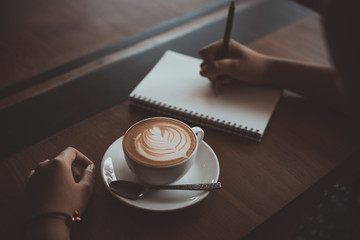 cup of coffee latte art on the wood desk coffee shop cafe