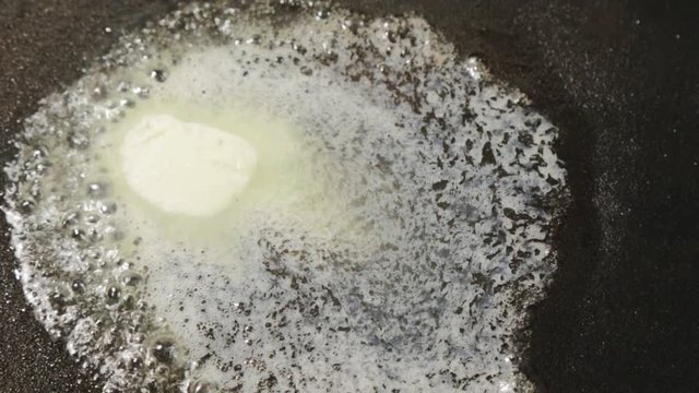 butter melting in black pan