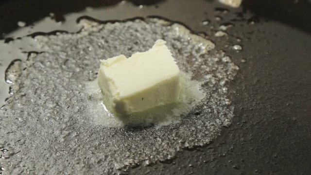 butter melting in black pan