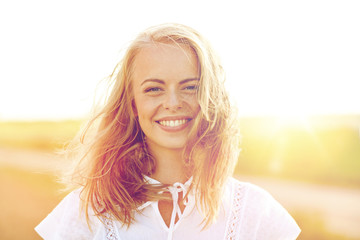 close up of happy young woman in white outdoors