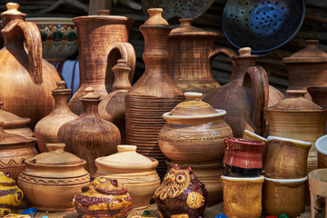 Fototapeta na wymiar Ceramic dishes (pots, bottles and cups) handmade in natural sunlight