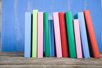 Stack of books on a blue background.