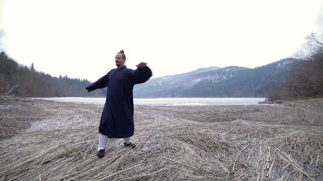 Martial Arts Kung Fu Man Training in Middle of Frozen Nature 4K