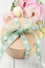 Eustoma flower and gift box with star green ribbon