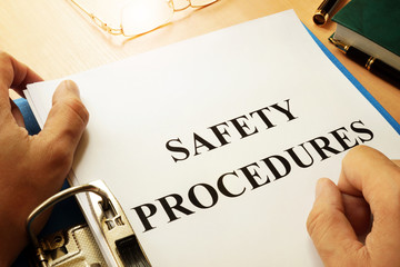 Safety procedures in a blue folder. Work Safety concept. - obrazy, fototapety, plakaty