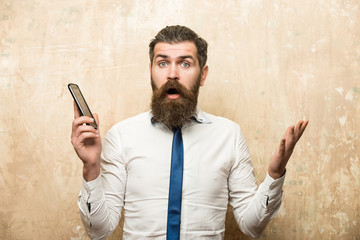man or hipster with long beard hold mobile phone