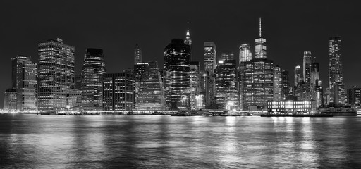 Black and white panoramic picture of Manhattan at night, New York City, USA.