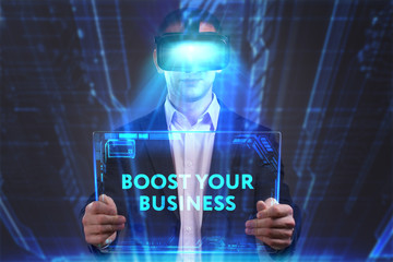 Business, Technology, Internet and network concept. Young businessman working in virtual reality glasses sees the inscription: Boost your business