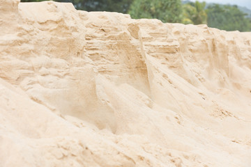 Crumbling shore by the sea from pure sand on a sunny day