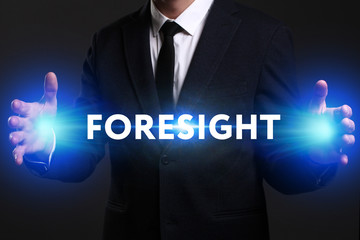 Business, Technology, Internet and network concept. Young businessman working on a virtual screen of the future and sees the inscription: Foresight