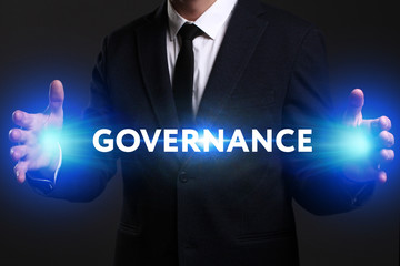 Business, Technology, Internet and network concept. Young businessman working on a virtual screen of the future and sees the inscription: Governance
