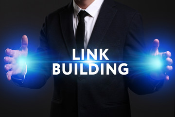 Business, Technology, Internet and network concept. Young businessman working on a virtual screen of the future and sees the inscription: Link building