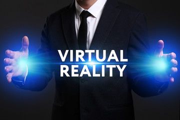 Business, Technology, Internet and network concept. Young businessman working on a virtual screen of the future and sees the inscription: Virtual reality