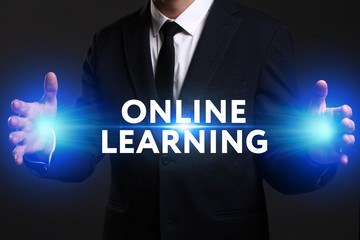 Business, Technology, Internet and network concept. Young businessman working on a virtual screen of the future and sees the inscription: Online learning