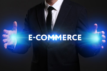 Business, Technology, Internet and network concept. Young businessman working on a virtual screen of the future and sees the inscription: E-commerce
