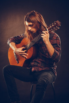 Guitarist is playing the guitar.