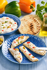Feta cheese spread with olives and pepper served with pita bread. Greek style dish.