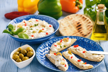 Feta cheese spread with olives and pepper served with pita bread. Greek style dish.