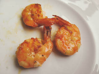 Grilled shrimps with spice and lemon in a white dish. Grilled seafood.