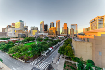 Aerial view downtown Houston illuminated at sunset with green city park and modern skylines light. The most populous city in Texas, fourth-most in United States. Architecture and travel background.