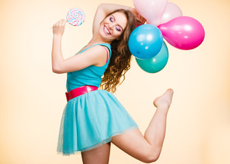 Woman with colorful balloons and lollipop