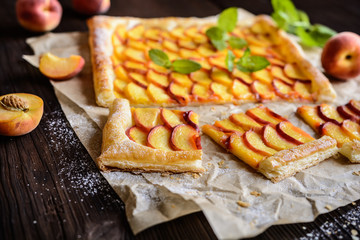 Delicious puff pastry pie topped with sliced peach