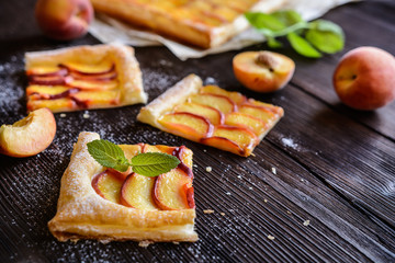 Delicious puff pastry pie topped with sliced peach