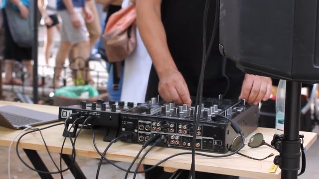 DJ hand mix dance music with mixer outdoor on May in Vilnius. Street music day. HD