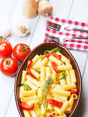 From above bowl with vegetable served on table with fresh tomatoes and garlic. Horizontal studio shot.