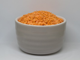  orange lentils in the grey cup