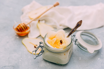 home sweet yogurt with pear and honey  in a glass jar