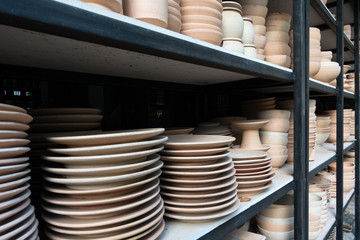 stack raw ceramic on black and white shelf