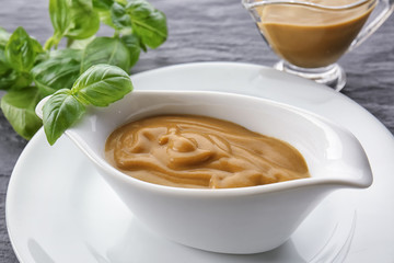Sauce boat with turkey gravy on table