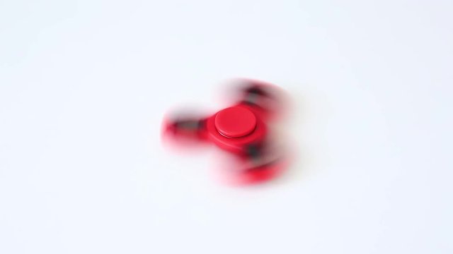 close up of popular toy fidget spinner rotating over white