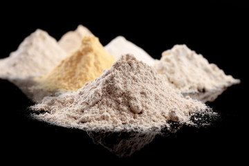 Different types of flour on black background