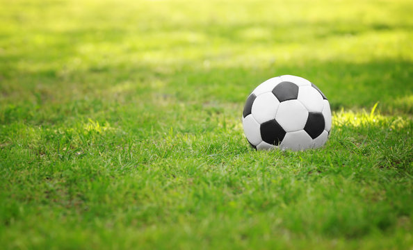 Soccer ball on green grass in park