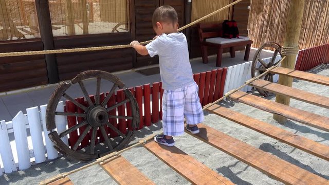 4K Child plays on rope ladder